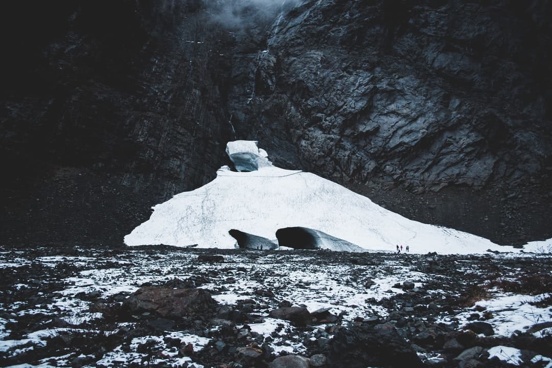 ice caves in the wild landscape photo of ice near gray cliff